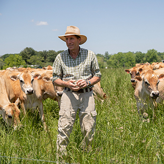 farmer in pasture with cows
